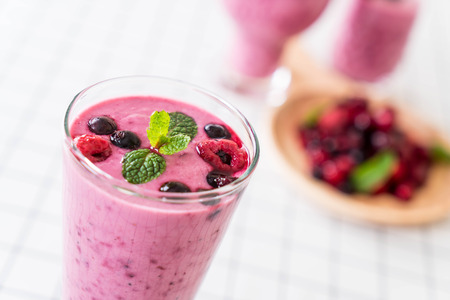mixed berries with yogurt smoothies on the tableの写真素材