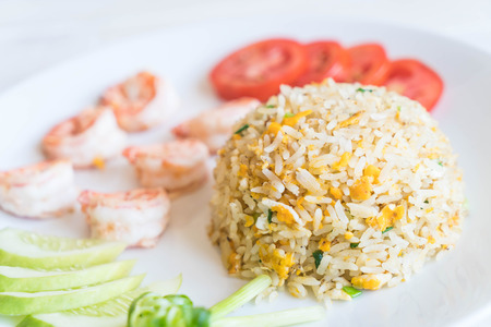 fried rice with shrimps on wood backgroundの写真素材