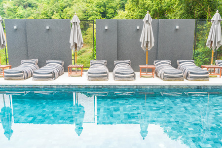 Beautiful luxury umbrella and chair around outdoor swimming pool in hotel and resortのeditorial素材