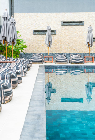 Beautiful luxury umbrella and chair around outdoor swimming pool in hotel and resortのeditorial素材