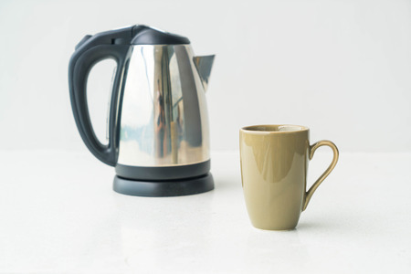 kettle and cup  on wall background with copy spaceの写真素材
