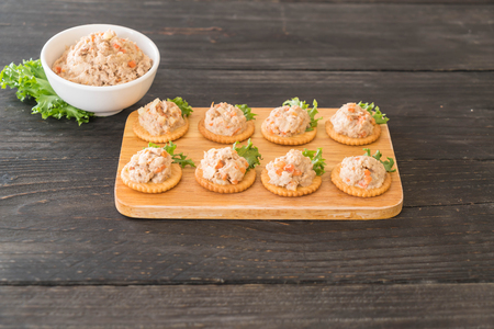 tuna spread with cracker on wood boardの写真素材