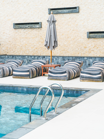 Beautiful luxury umbrella and chair around outdoor swimming pool in hotel and resortのeditorial素材
