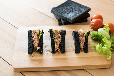 tuna charcoal  sandwich on wood tableの写真素材