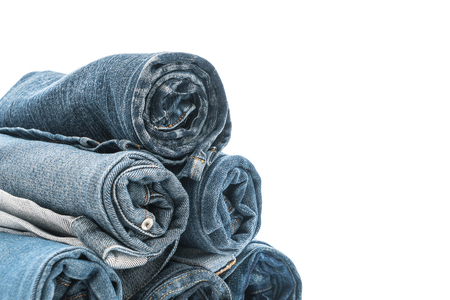 stacks of jeans clothing on white backgroundの写真素材