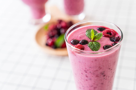 mixed berries with yogurt smoothies on the tableの写真素材