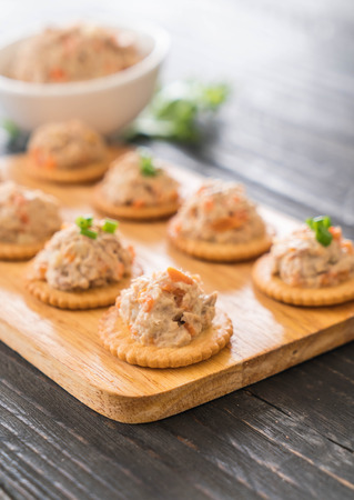 tuna spread with cracker on wood boardの写真素材