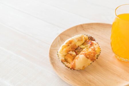sausage mayonnaise bread with orange juice on wood plateの写真素材
