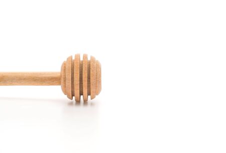 wooden honey stick on white backgroundの写真素材