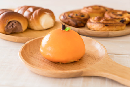 orange cake on wood plateの写真素材