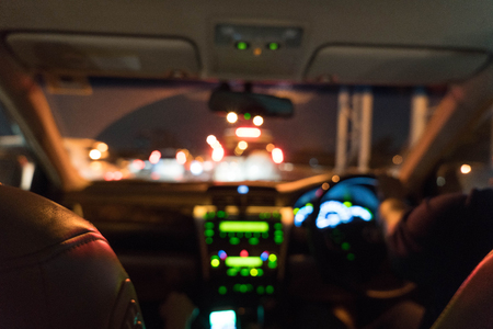 abstract blur people driving with playing smartphoneの写真素材