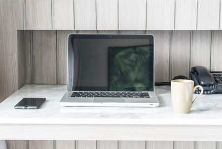 coffee cup with laptop and beautiful luxury table decoration in livingroom interior for background - vintage filterの写真素材