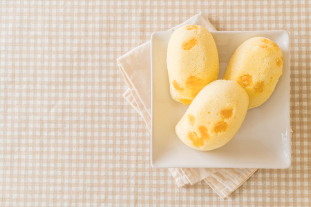 mango soft cake on wood backgroundの写真素材