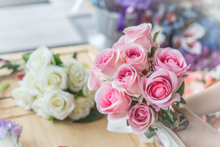 Hands holding bouquet of flower - vintage lighting styleの写真素材