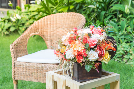 empty chair with bouquet flower decoration in the gardenの写真素材