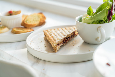 sandwich with salad on white plateの写真素材