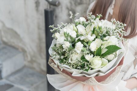 Hands holding bouquet of flower - vintage lighting styleの写真素材