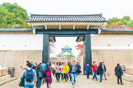 OSAKA, JAPAN - NOV 20 : Visitors crowded at Osaka Castle Park. It is a public urban park and historical site situated at Osaka, Japan.のeditorial素材
