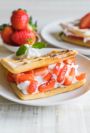 waffle with strawberry on wood tableの写真素材