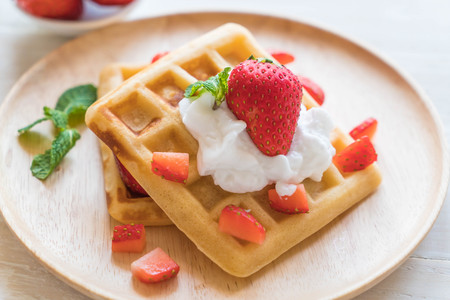 waffle with strawberry on wood tableの写真素材