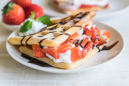 waffle with strawberry on wood tableの写真素材