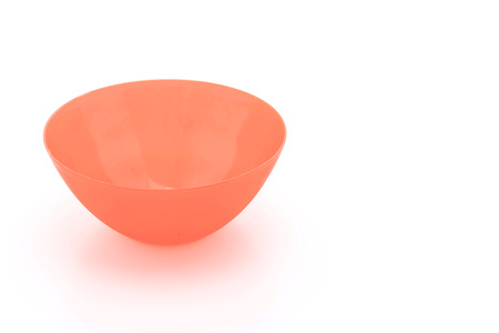 red plastic bowl on white backgroundの写真素材