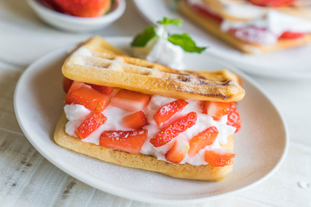 waffle with strawberry on wood tableの写真素材