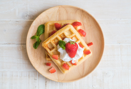 waffle with strawberry on wood tableの写真素材