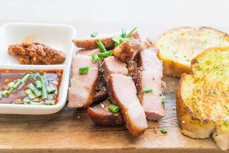 charcoal-boiled pork neck with garlic bread and spicy sauceの写真素材