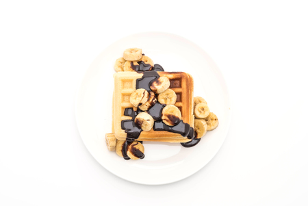 banana waffle with chocolate on white backgroundの写真素材