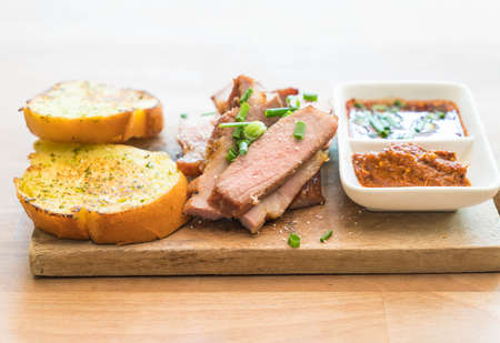 charcoal-boiled pork neck with garlic bread and spicy sauce