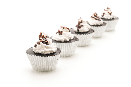 chocolate cup cake with whipped cream on white backgroundの写真素材