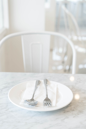 empty plate on dinning table - vintage lighting filterの写真素材