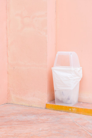 recycle bin on pink wall with copy spaceの写真素材