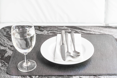 empty plate on dinning table with glassの写真素材