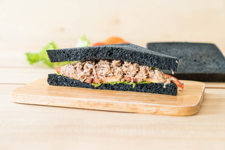 tuna charcoal  sandwich on wood boardの写真素材