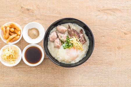 rice porridge with pork and egg with ingredientの写真素材