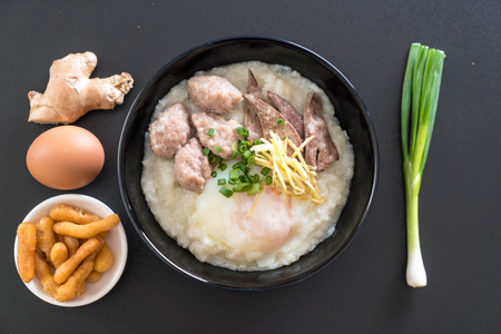 rice porridge with pork and egg with ingredientの写真素材