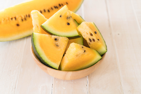 fresh yellow watermelon on woodの写真素材