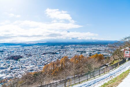 kawaguchiko city skyline with snow and cloudyの写真素材