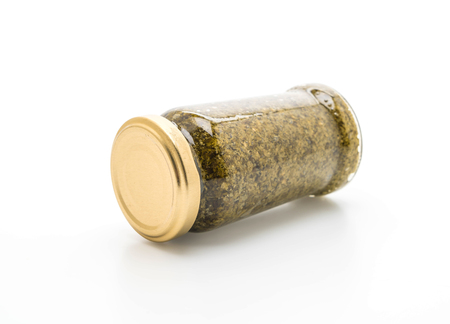 basil pesto jar isolated on white backgroundの写真素材