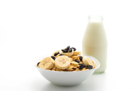 cereal with banana, raisin and milk for breakfast isolated on white backgroundの写真素材
