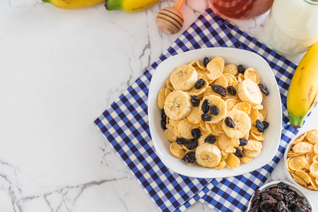 cereal with banana, raisin and milk for breakfastの写真素材