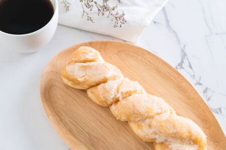 fresh butter roll bread on wood plateの写真素材