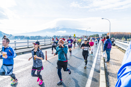 Kawaguchiko, JAPAN - Nov 27, 2016: Kawaguchiko Marathon 2016. People running on the bridge crossing Kawaguchiko Lake.のeditorial素材
