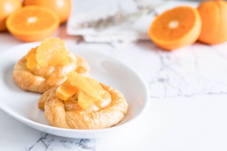 orange tart on white plateの写真素材