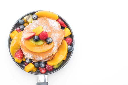 pancake with mix fruits (strawberry, blueberries, raspberries, mango, kiwi) on white backgroundの写真素材