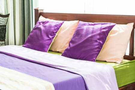 Beautiful pillow on bed interior decorationの写真素材