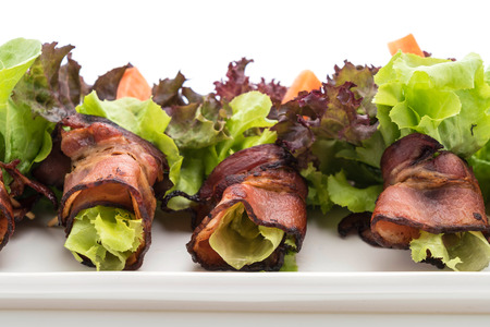 salad roll with bacon on white backgroundの写真素材