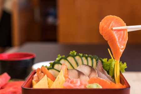 Raw fresh sashimi with rice in bento box - japanese food styleの写真素材